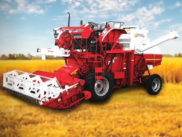 Tractor-mounted combine harvester in a wheat field